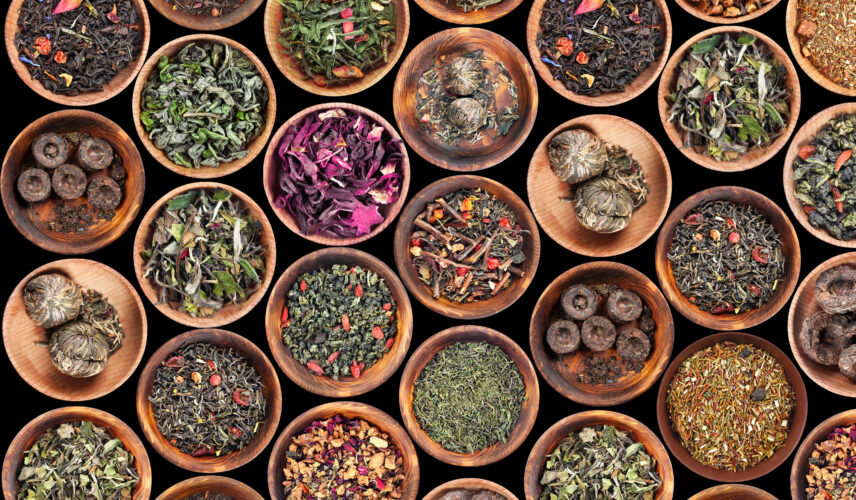 Set of different tea in saucer on black background