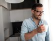 Handsome man having cup of coffee at home in the morning