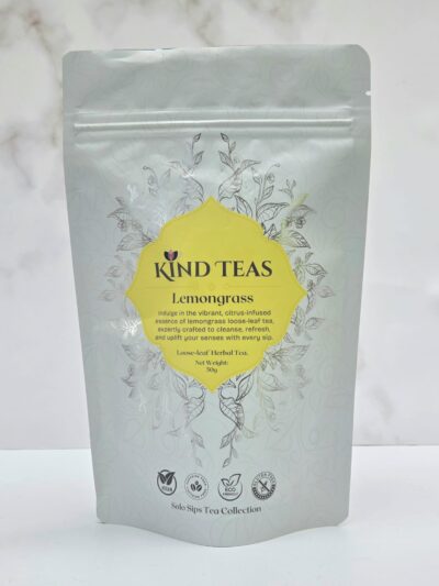 Kind Teas Lemongrass tea pouch with a yellow emblem and decorative botanical pattern on a light gray background.